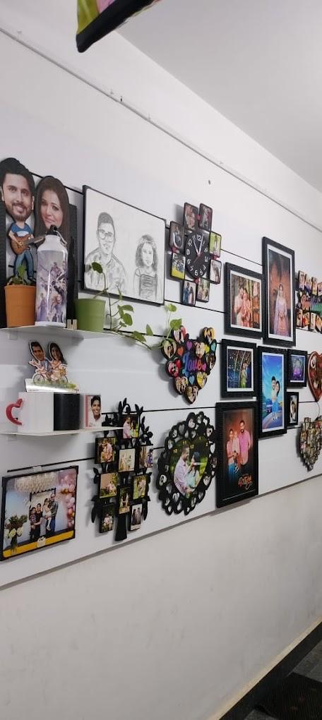 Wall of heart-shaped collages, tree-style photo frames and photo clocks