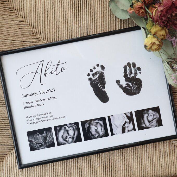 Framed newborn keepsake with inked hand and footprints beside ultrasound photos